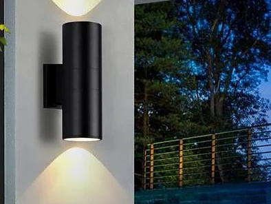 Exterior wall light illuminating a garden at night